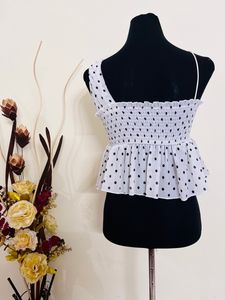 Dotted peplum top Black And White