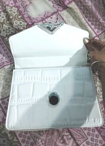 white hand purse