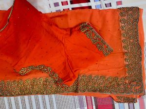 Vibrant Orange Saree with Stone Work and Ornate Em