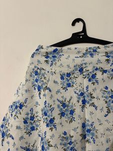 White skirt with a blue floral print