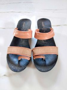 Sandal with a combination of peach and black colou
