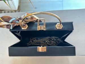 Structured Black Sling Bag with Golden Straps