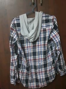 Stylish boys&#39; plaid shirt with an attached hoodie.