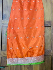 orange colour silk saree with green mundani