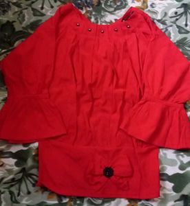 A Red Top With Some Black Details