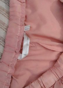 Pretty pastel pink satin shorts with ruffle detail