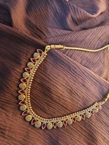 Elegant Gold-Tone Necklace with Red Accents
