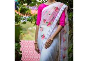 Embroidered netted saree with boat neck bl