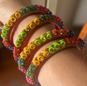 combo of wooden, golden and designer bangles