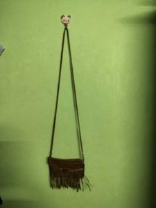 BROWN TASSLED SLING BAG