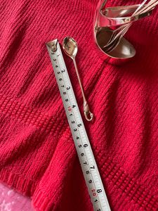 Product: Swan desert spoon stand. Material: Nickle