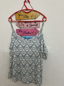 Cold-shoulder top with spaghetti straps.