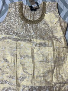 A Traditional Gold Top With Beautiful Neck To