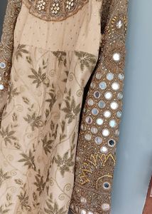 A golden mirror work on jorget suit . with neck work and sleeves fully work completed with salvar and dupatta