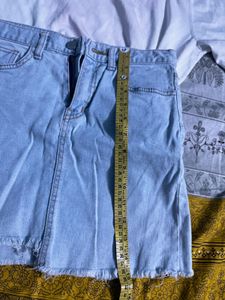 white printed top with blue mini denim skirt