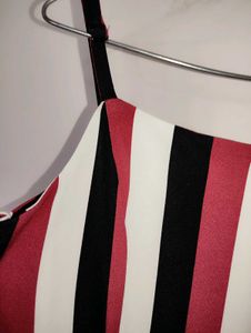 fitted bodice and down to elongated flared Pants