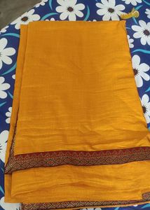 A Light Organe Saree With Red Broad Embroidery
