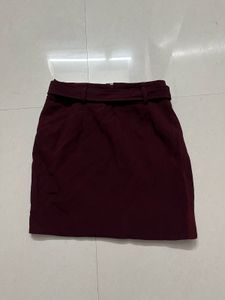 burgundy ruffled mini skirt with a belt.