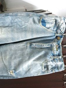 A ripped blue denim jeans