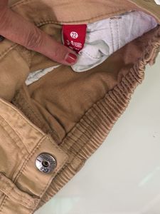 one black T-shirt with beige trousers