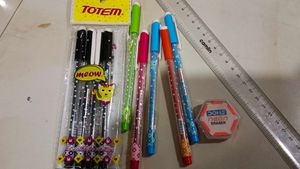 combo of pens scale and eraser