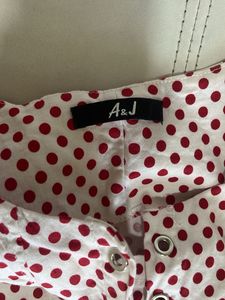 white top with red polka dots
