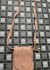 Elegant Pink Sling Bag with Embellished Sunburst
