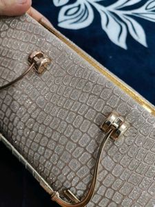 A brand new sparkly gold clutch