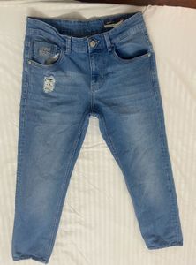 Light blue denim jeans with a cool distressed look