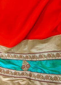 Orange Saree With Turquoise And GoldenBorder