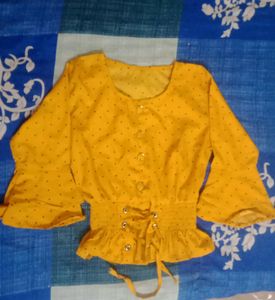 A Mustard Yellow Cinched Waist Top .