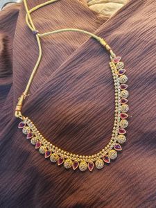 Elegant Gold-Tone Necklace with Red Accents