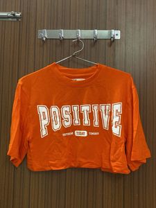 Orange 'Positive' Graphic Crop Top