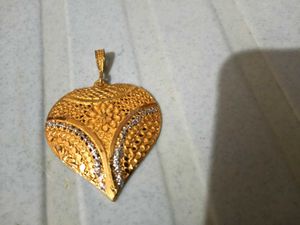 Gold Tone Pendant With Intricate Woven Texture