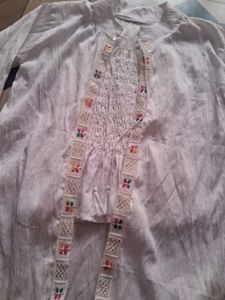 Its A White Top Wear With Multicolor Embroidery