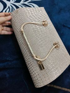 A brand new sparkly gold clutch