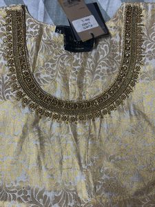 A Traditional Gold Top With Beautiful Neck To