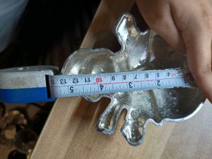 A Shiny Silver Snowman Figurine With Top Hat