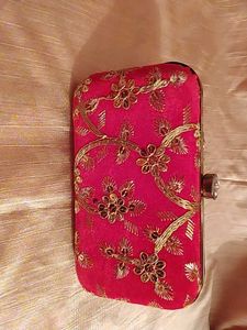 red clutch with zari work