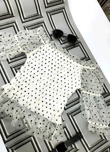 white, sheer top with black polka dots