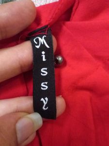 A Red Top With Some Black Details