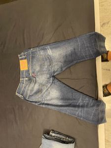 Distressed Mid-Wash Levi’s Jeans”