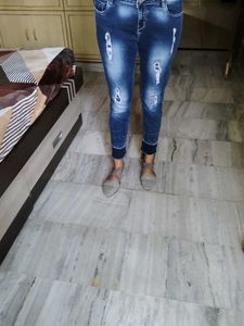 Navy Blue Ripped Jeans With A Design On Bottom