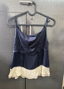 A Navy Blue &amp; Cream Coloured Tank Top.