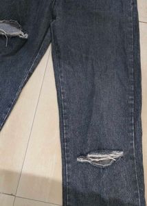 Unisex wide-leg distressed jeans.