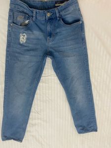 Light blue denim jeans with a cool distressed look