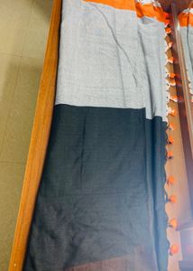 Black orange cotton blend saree with pompoms