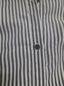 An Elegant Dress With Grey Stripes On White Base