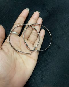large silver-toned hoop earrings.