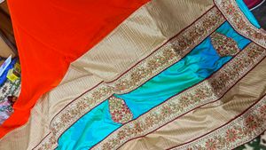 Orange Saree With Turquoise And GoldenBorder